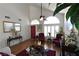 Living room with hardwood floors, a white couch, and large arched windows at 9843 Frosty Canyon Ct, Las Vegas, NV 89183