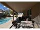 Covered patio with pool, seating area, and ceiling fan at 9843 Frosty Canyon Ct, Las Vegas, NV 89183