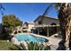 Relaxing pool area with a covered patio, comfortable seating, and a beautifully landscaped yard at 9843 Frosty Canyon Ct, Las Vegas, NV 89183