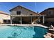 Large backyard pool with a covered patio and outdoor seating area at 9843 Frosty Canyon Ct, Las Vegas, NV 89183