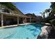 Stunning pool with a large patio, covered pergola, and string lights at 9843 Frosty Canyon Ct, Las Vegas, NV 89183