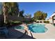 Relaxing pool and spa area with a rock waterfall feature and lush landscaping at 9843 Frosty Canyon Ct, Las Vegas, NV 89183