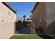 Side yard access with a gated entrance between neighboring houses at 9843 Frosty Canyon Ct, Las Vegas, NV 89183