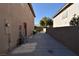 Side yard access with a concrete driveway and a red storage door at 9843 Frosty Canyon Ct, Las Vegas, NV 89183