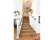 Elegant staircase with brown carpeting leading to upper level at 9843 Frosty Canyon Ct, Las Vegas, NV 89183