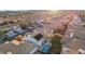 Aerial view of a residential backyard featuring a pool with patio, surrounded by well-maintained homes in a desert community at 9916 Sierra Canyon Way, Las Vegas, NV 89147