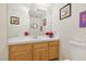 Cozy half bathroom with classic vanity and decorative mirror at 9916 Sierra Canyon Way, Las Vegas, NV 89147