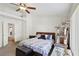 Bright bedroom featuring a ceiling fan, a bed with floral bedding, a cat tree and furniture at 9916 Sierra Canyon Way, Las Vegas, NV 89147