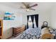 Cozy bedroom with large window, mounted television, dark curtains, ceiling fan and overhead lighting at 9916 Sierra Canyon Way, Las Vegas, NV 89147