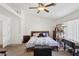 Bright bedroom featuring a ceiling fan, a bed with floral bedding, a cat tree and furniture at 9916 Sierra Canyon Way, Las Vegas, NV 89147