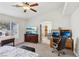 Bright bedroom featuring a mounted television, work space and light walls at 9916 Sierra Canyon Way, Las Vegas, NV 89147