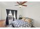 Cozy bedroom with large window, dark curtains, ceiling fan and overhead lighting at 9916 Sierra Canyon Way, Las Vegas, NV 89147