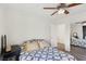 Cozy bedroom with large window, dark curtains, ceiling fan and access to mirrored closet at 9916 Sierra Canyon Way, Las Vegas, NV 89147