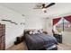 Comfortable bedroom featuring a ceiling fan, window, and stylish decor at 9916 Sierra Canyon Way, Las Vegas, NV 89147