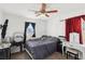 Cozy bedroom with large window, dark curtains, ceiling fan and overhead lighting at 9916 Sierra Canyon Way, Las Vegas, NV 89147