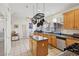 Spacious kitchen featuring tile floors, a center island, and stainless steel appliances at 9916 Sierra Canyon Way, Las Vegas, NV 89147