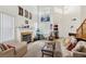 A bright living room features a fireplace, high ceilings and large windows at 9916 Sierra Canyon Way, Las Vegas, NV 89147