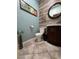 Stylish bathroom with wood vanity, decorative wall, and tiled floor at , Henderson, NV 89011