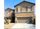 Two-story house with beige exterior and brown shutters at 1136 Buckhorn Cove St, Henderson, NV 89011