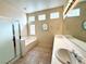 Bright bathroom with a double vanity, soaking tub, and glass-enclosed shower at 8682 Waterford Bend St, Las Vegas, NV 89123