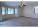 Spacious bedroom with natural light from the large window and a ceiling fan at 8682 Waterford Bend St, Las Vegas, NV 89123