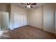 Bright bedroom with wood flooring, double closet, ceiling fan, and ample natural light at 8682 Waterford Bend St, Las Vegas, NV 89123