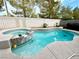 Backyard pool and spa features elegant tilework, mature trees, and sunny views, perfect for outdoor relaxation at 8682 Waterford Bend St, Las Vegas, NV 89123