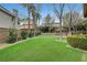 Landscaped backyard with artificial turf and mature trees at 10213 Owls Peak Ct, Las Vegas, NV 89144