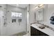 Modern bathroom with a walk-in shower, pebble floor, and stylish vanity at 10213 Owls Peak Ct, Las Vegas, NV 89144