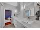 Double vanity bathroom with modern finishes and a view into another room at 10213 Owls Peak Ct, Las Vegas, NV 89144