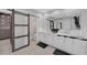 Modern bathroom with double vanity, marble countertops, and barn door at 10213 Owls Peak Ct, Las Vegas, NV 89144