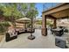 Outdoor patio with seating area, dining table, and umbrella at 10213 Owls Peak Ct, Las Vegas, NV 89144