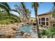 Stunning pool and spa with rock waterfall feature; view from above at 10213 Owls Peak Ct, Las Vegas, NV 89144