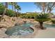 Resort-style pool with a waterfall and lush landscaping at 10213 Owls Peak Ct, Las Vegas, NV 89144