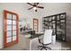 Virtually staged home office with built-in shelving and desk at 1036 Aspen Daisy Ave, Henderson, NV 89074