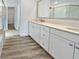 Bathroom with double vanity, beige countertop, and large mirror at 10425 Seelos St, Las Vegas, NV 89178