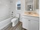 Clean bathroom with a toilet, bathtub, and vanity with a quartz countertop at 10425 Seelos St, Las Vegas, NV 89178