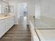 Elegant bathroom featuring a soaking tub, double vanity, and glass shower enclosure at 10425 Seelos St, Las Vegas, NV 89178