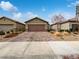 House exterior featuring a brown garage door and brick paver driveway at 10425 Seelos St, Las Vegas, NV 89178