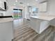 Modern kitchen with white cabinets, quartz countertops, and sliding glass door to backyard at 10425 Seelos St, Las Vegas, NV 89178