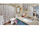 Well-lit bathroom featuring a granite countertop, sink, and patterned shower curtain at 10550 W Alexander Rd # 1007, Las Vegas, NV 89129