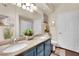 Bathroom with a double sink vanity, granite countertops, and modern fixtures at 10550 W Alexander Rd # 1007, Las Vegas, NV 89129