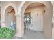 Charming entrance featuring arched detailing, a secure metal door, a seating area, and decorative angel statue at 10550 W Alexander Rd # 1007, Las Vegas, NV 89129