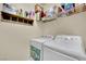 Functional laundry area with a washer, dryer, shelving, and organized storage at 10550 W Alexander Rd # 1007, Las Vegas, NV 89129