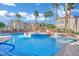 Resort-style community pool with blue water and several palm trees at 10550 W Alexander Rd # 1007, Las Vegas, NV 89129