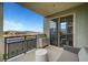 Relaxing balcony view with seating, sliding glass doors, and beautiful city views at 11250 Hidden Peak Ave # 208, Las Vegas, NV 89135