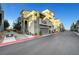 Beautiful townhome featuring neutral colored stucco with a garage and stairs leading to the front door at 11250 Hidden Peak Ave # 208, Las Vegas, NV 89135