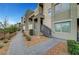 Modern townhome showcasing neutral colors, balconies, metal staircases and landscaped walkway at 11250 Hidden Peak Ave # 208, Las Vegas, NV 89135