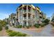 Exterior angle view of a townhome featuring neutral-toned stucco with a balcony and a walking path at 11250 Hidden Peak Ave # 208, Las Vegas, NV 89135