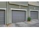 Close-up of a gray garage door with clean lines, complemented by minimal landscaping at 11250 Hidden Peak Ave # 208, Las Vegas, NV 89135